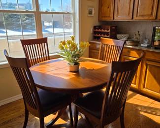 Cherry wood round table with leaves & four chairs purchased from the  Amish Furniture Gallery 