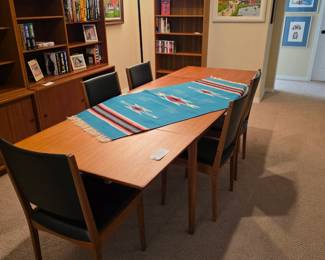 Vintage Danish Modern teak table in expanded position with chairs.