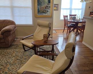Pair of sling back chairs, view into kitchen, original painting of wolves by noted Taos artist