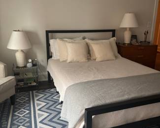 Modern Black Metal Platform Bed Frame with Geometric Rug and Neutral Bedding