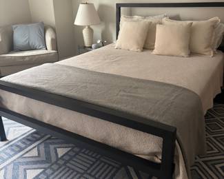 Modern Black Metal Platform Bed Frame with Geometric Rug and Neutral Bedding