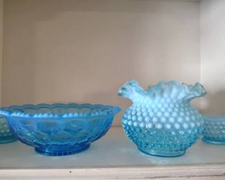 Fenton blue hobnail vase and Northwood blue opalescent glass .