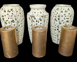 Three White Candleholders With Candles