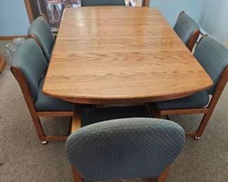 Oak Dining Table with Four Upholstered Chairs with Casters second image