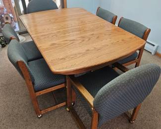 Oak Dining Table with Four Upholstered Chairs with Casters