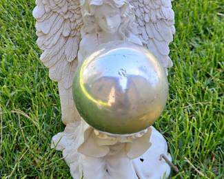 Angel holding sphere garden statue
