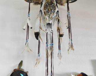 Steer skull with feathers, fur and beads