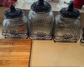 Set of Vintage Glass Canisters with Ornate Black Lids and Metal Caddy