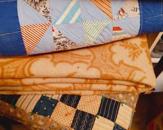 A couple quilts and wool blanket