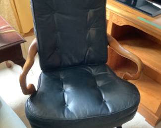 Green leather office chair with wooden arm, and castors.  Presale $75
