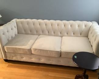 White chesterfield sofa which has matching chair.  Sits firm.  Presale $695