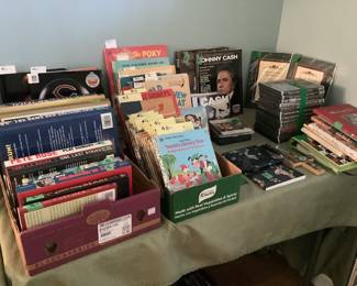 Several sports themed books, Childrens books including golden books, books and CDs by Johnny Cash, and self help books