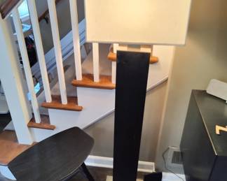 Lamp with After J63 Johansson is a stool designed by Ejvind A. Johansson for the Fredericia brand. It is made of solid black ash wood, with a plywood seat