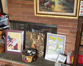 Framed and matted artwork, vintage enemy propaganda prter pan scandal advertising and tin full of buttons.