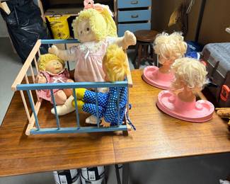 Vintage baby gate on wheels, Cabbage Patch dolls and Barbie school of beauty stations.