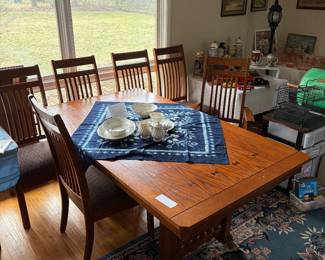 Mission style dining room table with one leaf and six matching chairs.