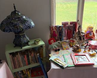 Tiffany lamp, children’s books and Barbie dolls still in boxes.
