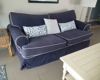 Cozy navy couch with white piping