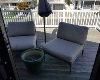 Contemporary outdoor chairs; large green pot
