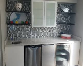 Built-in wet bar with floating shelves; track lights; decor & serve ware