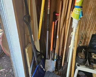 Various shovels rakes and tools