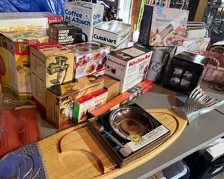 Assortment of Kitchen Gadgets including KitchenAid Food Grinder, Cuisinart Food Processor Attachment, Cookie Presses, Spiralizer, and Community Silverplate Serving Dish