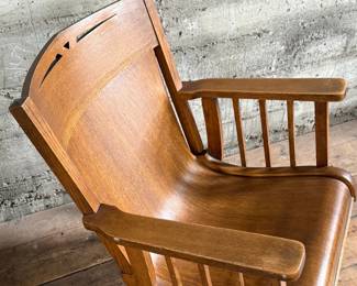 This lot features an antique Mission Arts and Crafts style rocking chair, with a curved back and in good sturdy condition. This chair measures, 33” H x 25” W x 30” D.