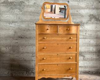This lot features a stunning highboy dresser with a harp mirror with six (6) drawers and sitting on casters. This dresser measures with mirror, 65” H x 33.5” W x 18” D.