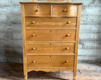 This lot features a stunning highboy dresser with a harp mirror with six (6) drawers and sitting on casters. This dresser measures with mirror, 65” H x 33.5” W x 18” D.