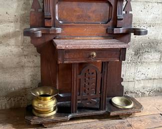 This lot features a stunning late 19th century Eastlake Victorian hall tree with a marble top drawer, umbrella trays, and brass hooks. This piece measures, 84” H x 35” W x 12” D.
