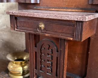 This lot features a stunning late 19th century Eastlake Victorian hall tree with a marble top drawer, umbrella trays, and brass hooks. This piece measures, 84” H x 35” W x 12” D.