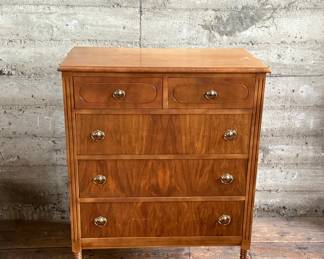 This lot features an antique highboy chest of drawers, crafted with solid wood and dove-tailed drawers. Two smaller drawers up top and three larger below. This dresser measures, 43” H x 34” W x 19.5” D.