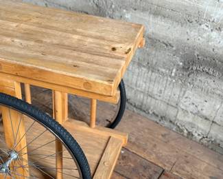 A whimsically designed Chopping Block Bar Cart by the noted California designer Bill W. Sanders. This design dates to the 1960’s. The bicycle tires may have been replaced at some point. The butcher block is in good condition. The bicycle wheels are a little wobbly when wheeled around but the cart is stable and sturdy. This cart measures, 29.5” H x 22” W x 34” D. A similar example is pictured in the book by the Pasadena Art Museum, California Design/Nine, Pasadena, 1965, Page 112.
