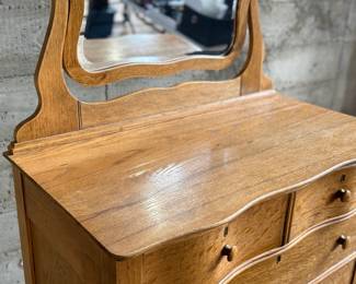 This lot features a stunning highboy dresser with a harp mirror with six (6) drawers and sitting on casters. This dresser measures with mirror, 65” H x 33.5” W x 18” D.