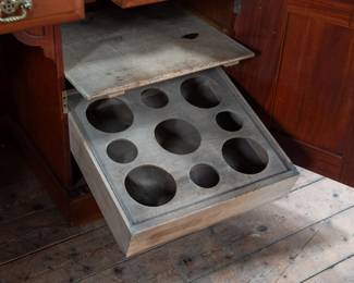 A large mahogany sideboard with an attached mirror by Aldis & Leggott, cabinet makers from Hull. The piece features four drawers, two side cabinets with pull-out shelves, and a specialized interior section for bottle storage. Decorative carvings on the legs and facade, as well as brass drawer pulls, highlight the craftsmanship. Dovetail joinery is observed on the drawers, indicating quality construction. The mirror shows minor silvering loss, and the wooden structure displays some signs of wear consistent with age, including small scratches and woodworm holes. Stamped “Aldis & Leggott, 17 Paragon Street, Hull”. This stunning sideboard measures 77” H X 78” W x 26” D.