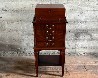 This lot features a Hardwick 4-drawer chest by Butler Speciality and a Reed & Barton utensil storage chest sitting on top. This piece measures (with top utensil box), 42” H x 18” W x 14” D.