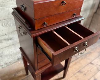 This lot features a Hardwick 4-drawer chest by Butler Speciality and a Reed & Barton utensil storage chest sitting on top. This piece measures (with top utensil box), 42” H x 18” W x 14” D.