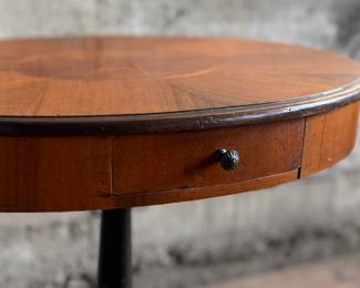 This lot features a 19th-century Biedermeier-style pedestal side table with a single drawer that measures, 20” H x 19” W x 13.5” D.