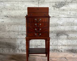 This lot features a Hardwick 4-drawer chest by Butler Speciality and a Reed & Barton utensil storage chest sitting on top. This piece measures (with top utensil box), 42” H x 18” W x 14” D.