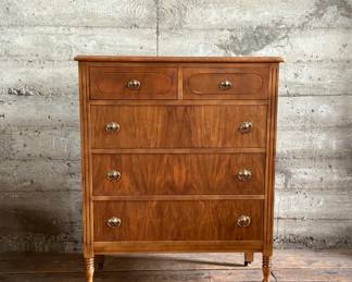 This lot features an antique highboy chest of drawers, crafted with solid wood and dove-tailed drawers. Two smaller drawers up top and three larger below. This dresser measures, 43” H x 34” W x 19.5” D.
