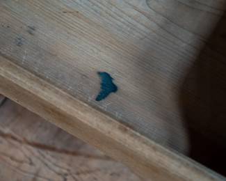 A large mahogany sideboard with an attached mirror by Aldis & Leggott, cabinet makers from Hull. The piece features four drawers, two side cabinets with pull-out shelves, and a specialized interior section for bottle storage. Decorative carvings on the legs and facade, as well as brass drawer pulls, highlight the craftsmanship. Dovetail joinery is observed on the drawers, indicating quality construction. The mirror shows minor silvering loss, and the wooden structure displays some signs of wear consistent with age, including small scratches and woodworm holes. Stamped “Aldis & Leggott, 17 Paragon Street, Hull”. This stunning sideboard measures 77” H X 78” W x 26” D.