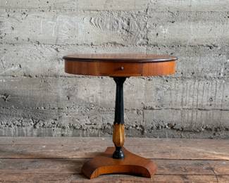 This lot features a 19th-century Biedermeier-style pedestal side table with a single drawer that measures, 20” H x 19” W x 13.5” D.