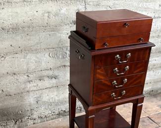 This lot features a Hardwick 4-drawer chest by Butler Speciality and a Reed & Barton utensil storage chest sitting on top. This piece measures (with top utensil box), 42” H x 18” W x 14” D.