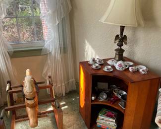 vintage rocking horse, china set, books, shelves, lamp