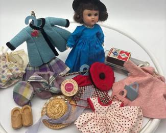 Vintage Vogue Ginny doll from the 1950s, accompanied by a collection of her miniature outfits