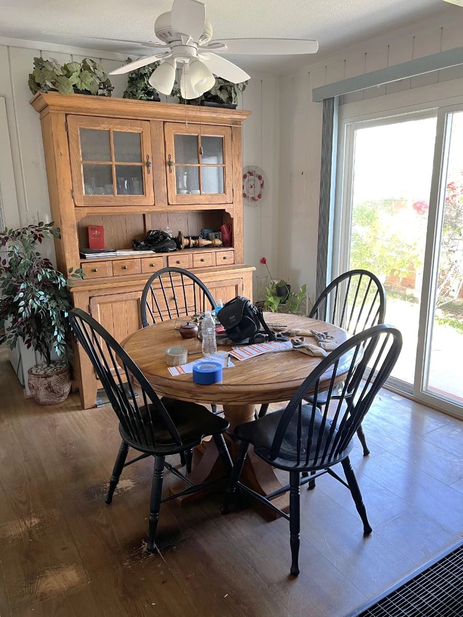 This shows a nice dining table and four matching chairs in the foreground, plus the kitchen hutch in the background.