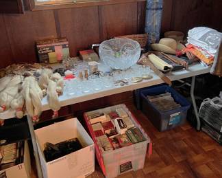 A punchbowl, ladle, and glasses are in this picture.  In the bucket on the floor are a number of Hallmark Christmas ornaments in their boxes.