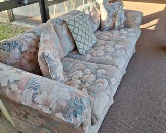 Pink/gray/blue floral couch with pillows