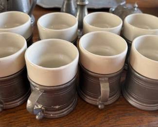 Pewter and white ceramic cups