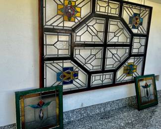 This is a massive! stained glass window and two smaller ones.  Period windows I believe!